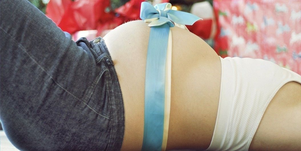 pregnant belly with ribbon