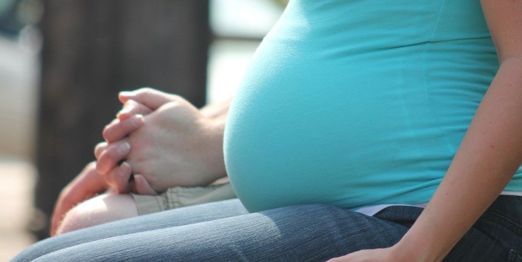 pregnant woman in blue shirt