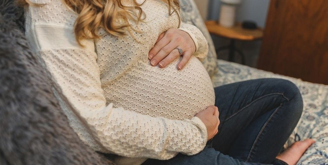 pregnant woman with hands on belly