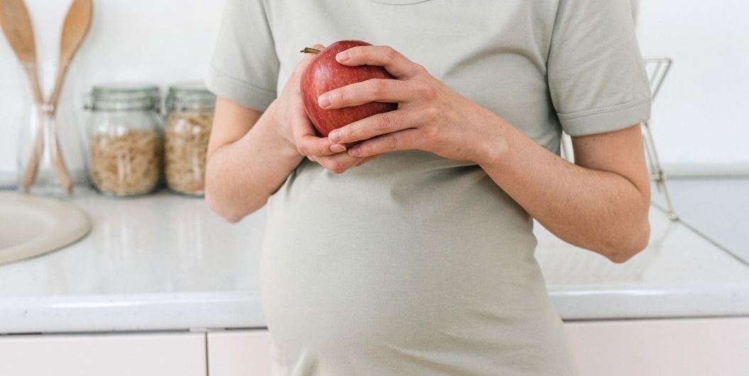 pregnant woman with an apple