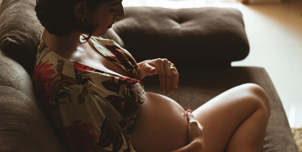 pregnant woman sitting on a couch