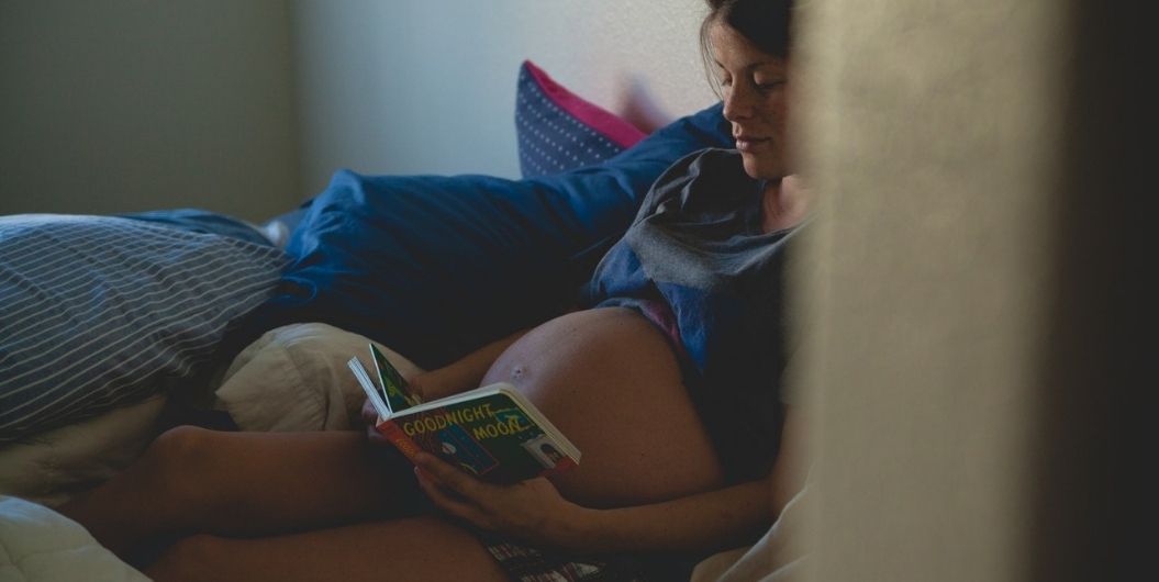 pregnant woman reading a book