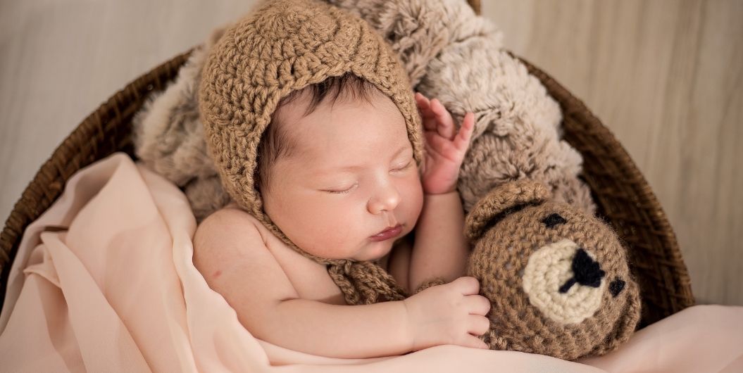 sleeping baby with a teddy bear