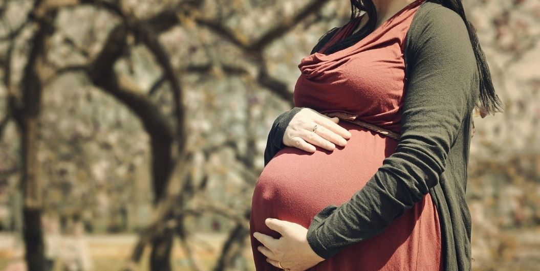 pregnant woman holding her huge belly