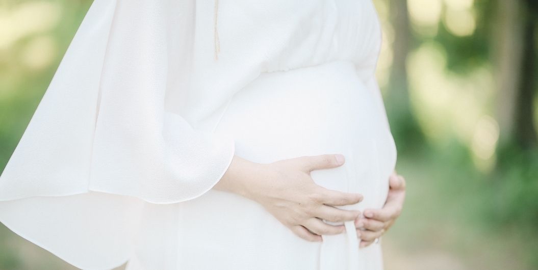 pregnant woman in a white dress