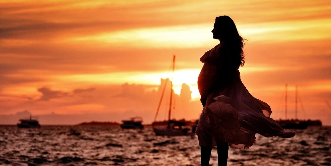 pregnant woman sunset beach