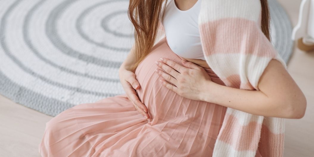 pregnant woman in peach dress