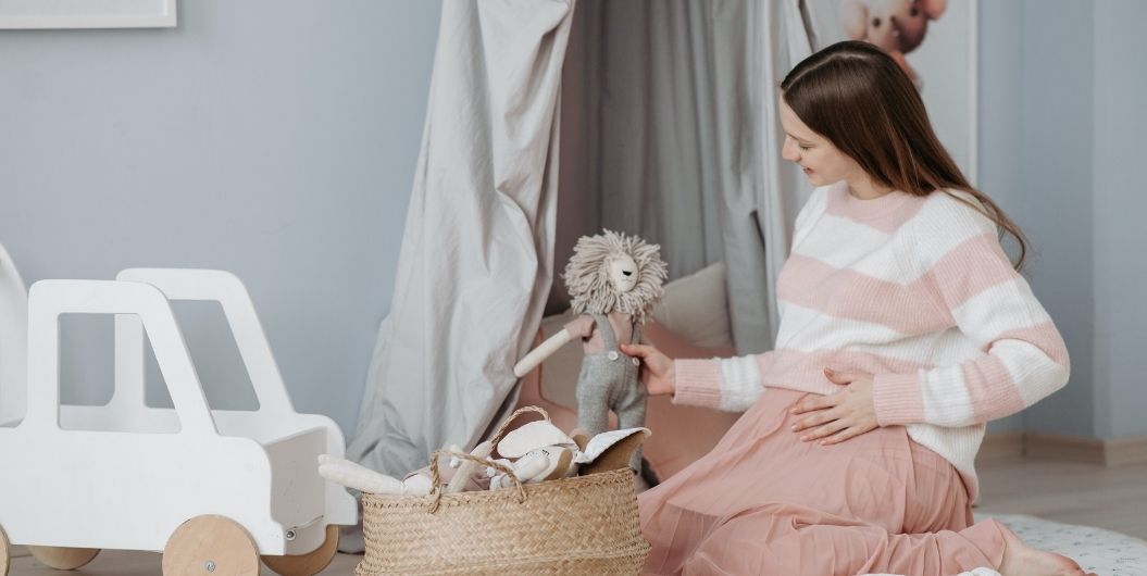 pregnant woman playing with toy