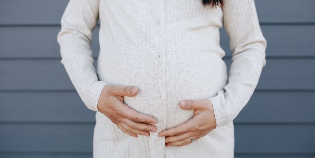 pregnant woman in a long-sleeved dress