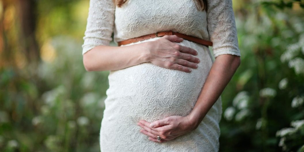 pregnant woman holding her belly