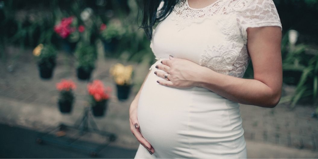 pregnant woman holding her belly